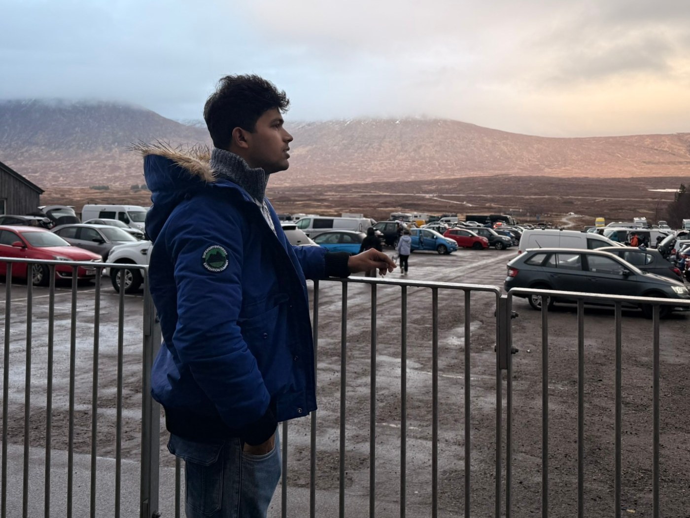 Prakash Saravanan, in profile, looking out over the Scottish highlands